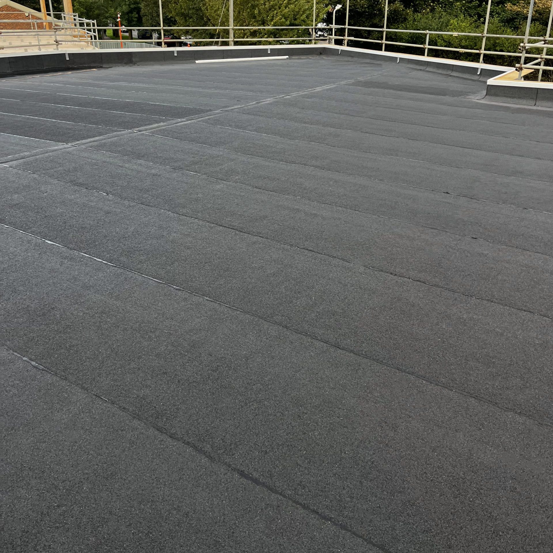 Felt roofing South East – torch-on felt system on a flat roof with perimeter edge protection